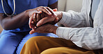 Nurse, console and holding hands in retirement home with old woman, support or compassion for mourning. Caregiver, senior person and comfort with solidarity, understanding and empathy for grief.