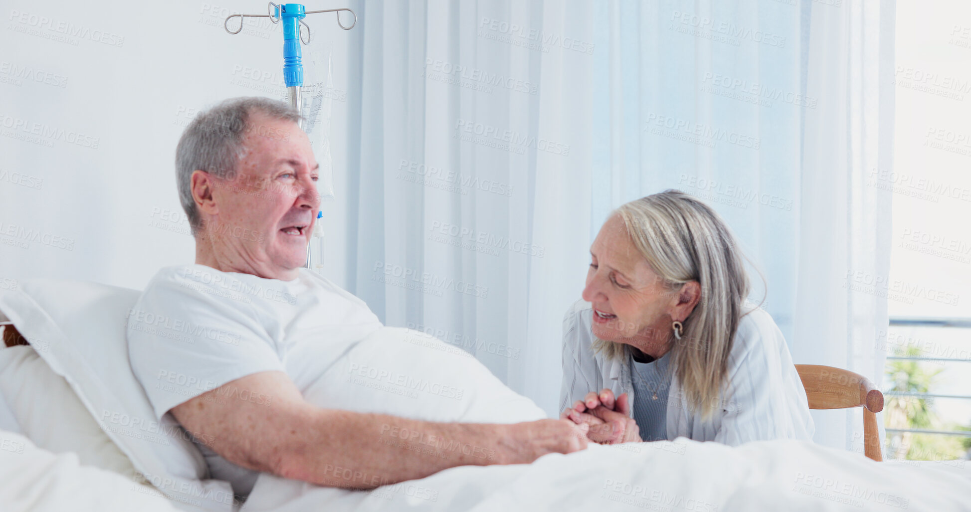 Buy stock photo Senior, couple or happy holding hands at hospital bed for recovery support, discharge news or relief. Marriage, elderly people or talk in geriatric ward for positive test results, healing or optimism