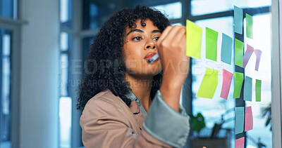 Buy stock photo Sticky notes, glass wall and businesswoman in office with planning for creative project ideas. Board, writing and magazine editor brainstorming with research for article at startup workplace.