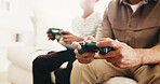 Break, gaming and hands of parent with child on living room sofa for bonding, competition or fun. Hobby, remote control and video game with family in home together for learning, playing or teaching