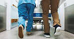 Doctor, nurse and legs walk with hospital bed, medical emergency and collaboration for patient care. Back, people and healthcare team moving in clinic hallway with gurney, help or journey to surgery.