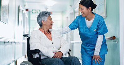 Buy stock photo Conversation, nurse and senior woman in wheelchair at hospital for consultation, healthcare or support. Happy, caregiver and elderly person with disability for medical checkup in clinic corridor.