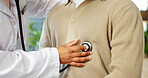 Doctor, patient and hands in clinic with stethoscope, cardiovascular assessment or medical checkup. Cardiologist, person and hearing breathing in office with healthcare tools, heart rate or wellness.