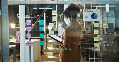 Buy stock photo Night, business and woman on tablet by glass for expense report, strategy and budget planning. Writing, tech and person with sticky notes for funding options, research or project management in office