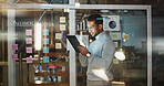 Planning, business and man on tablet by glass for data analysis, financial growth or research. Night, office and person with sticky notes, graph and tech for budget report, strategy or finance review