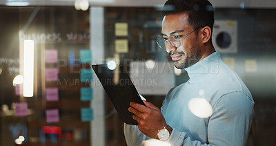 Buy stock photo Night, business and man on tablet in glass office for finance review, budget planning and research. Glasses, tech and person with sticky notes for funding options, strategy and project management