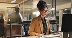 Reading, research and businesswoman with laptop in office, budget review or financial plan at night. Accountant, working late and person with tech, serious and checking expenses on web in business