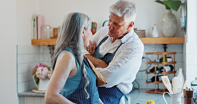 Buy stock photo Talk, cooking and love with old couple in kitchen for bonding, romantic gesture and meal prep. Connection, support and food with senior man and woman in home for retirement, trust and recipe