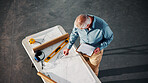 Blueprint, architecture and clipboard with above of man for building, construction site and renovation. Remodeling project, progress report and floor plan with mature person for engineer and layout