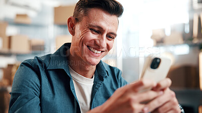 Buy stock photo Happy, man and phone in small business for logistics, driver update or track package in shipping. Supply chain, person or mobile app in storage for route search, digital invoice and delivery schedule