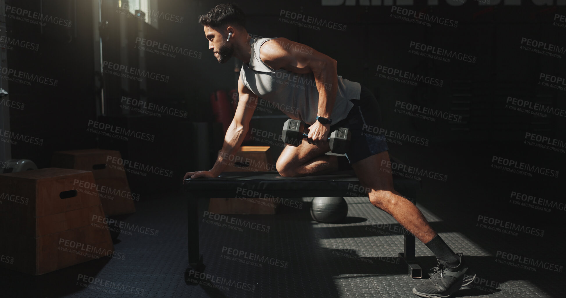 Buy stock photo Man, earphones and dumbbell exercise in gym with fitness, bodybuilding and listen to music playlist. Bodybuilder, person and audio tech in health club with radio, weightlifting and strength training.