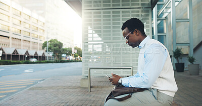 Buy stock photo Phone, bus stop and waiting with black man in city for travel schedule, communication and chat. Location update, appointment and connection with business person and tech outdoor for contact or typing