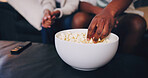 Home, couple and hand with popcorn for watching tv, streaming movie and bonding together on weekend. People, dating and eating corn snack in lounge with relationship, love and film for entertainment.
