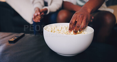 Buy stock photo Home, couple and hand with popcorn for watching tv, streaming movie and bonding together on weekend. People, dating and eating corn snack in lounge with relationship, love and film for entertainment.