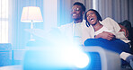 Laughing, projector and couple in home for watching movie, relax and bonding together with snacks. Black man, woman and streaming film in living room, comedy show and entertainment with popcorn
