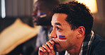 Man, sports and watching tv in home with waiting, anticipation and face paint with national flag. Fan, anxiety and streaming game with friends for tournament, live event and international competition