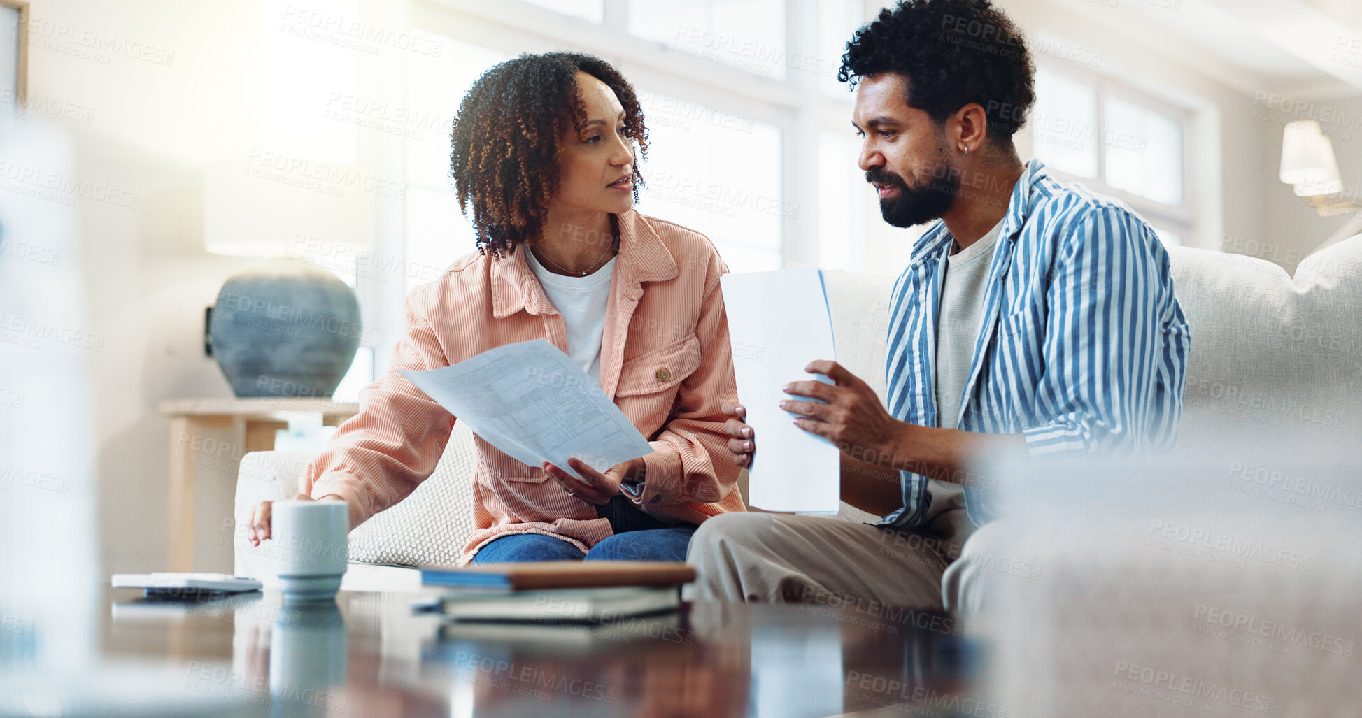Buy stock photo Finance, documents and couple with bills in home for budget planning or tax deduction on sofa. Man, woman or calculator with paperwork for financial audit, expenses or insurance together in house