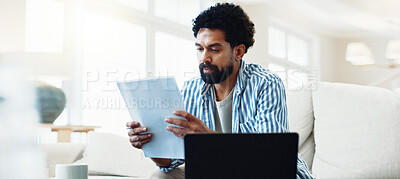 Buy stock photo Man, relax and reading at house with document, finance report and budget for household bills. Serious, male person and laptop in home with paperwork, financial invoice and bank statement for mortgage