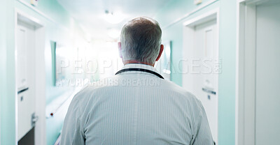 Buy stock photo Back, doctor and walking in clinic for healthcare, punctual person and wellness service. Mature man, hospital hallway and arrival of professional clinician, medical duty and shift at corridor