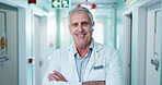 Medical, portrait or man in hospital with arms crossed, physician or pride as general practitioner. Ambition, happy or mature doctor with confidence, surgeon or about us in healthcare profession.