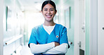 Medical, portrait or doctor in hospital with arms crossed, physician or pride as general practitioner. Ambition, happy or woman in lobby with confidence, surgeon or about us in healthcare profession.