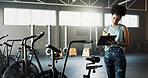 Woman, fitness or checklist with bicycle in gym for inventory inspection or workout equipment. Active, female person or checking clipboard with stationary bikes for functionality or quality assurance