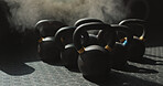 Background, gym and kettlebell on ground for bodybuilding, strength training or workout with smoke. Equipment, still life and wallpaper with group of weights in health club interior for development