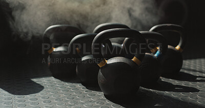 Buy stock photo Background, gym and kettlebell on ground for bodybuilding, strength training or workout with smoke. Equipment, still life and wallpaper with group of weights in health club interior for development