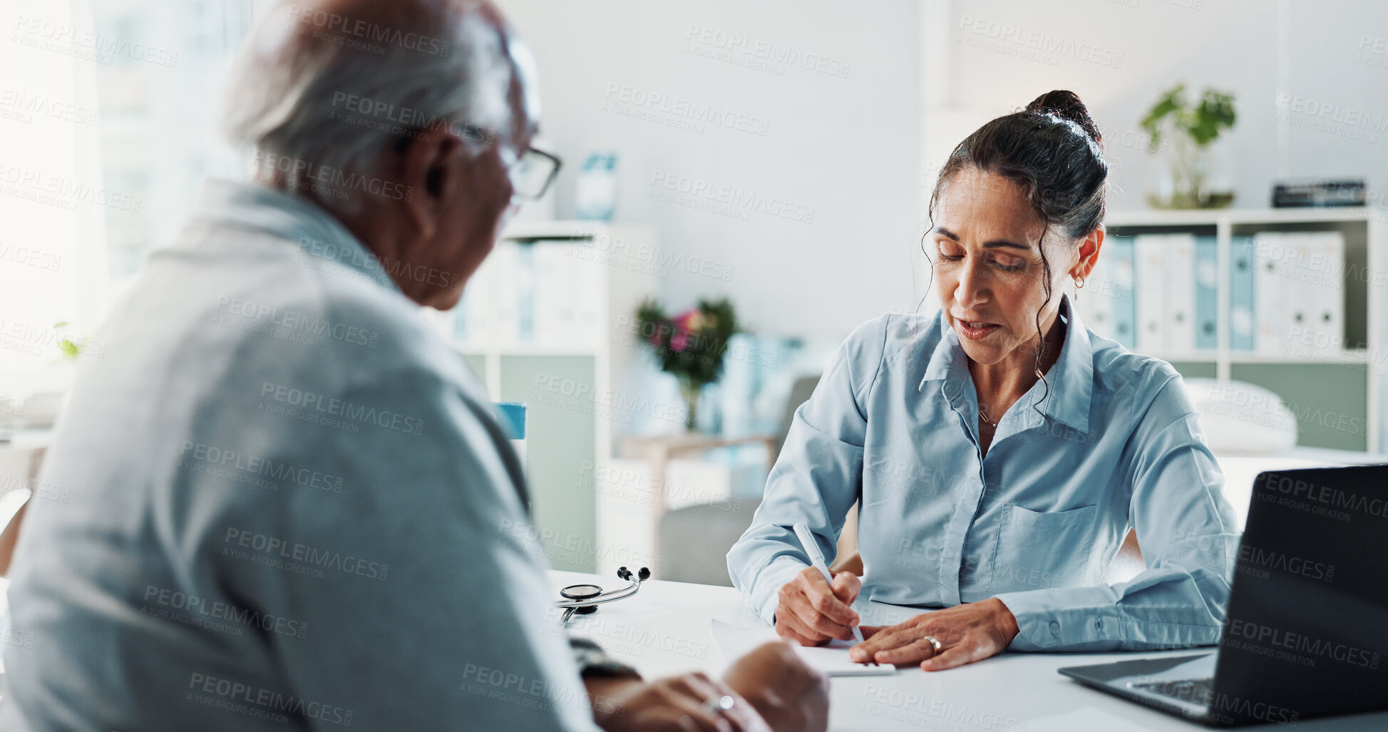 Buy stock photo Writing, doctor and consulting with old man in hospital for healthcare, prescription and checkup. Medical, treatment script and advice with senior patient in clinic for discussion, assessment