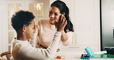Buy stock photo Mother, child and high five in house with homework, learning success and cognitive development goals. Happy, woman and son with celebration for understanding task, education and achievement in home.