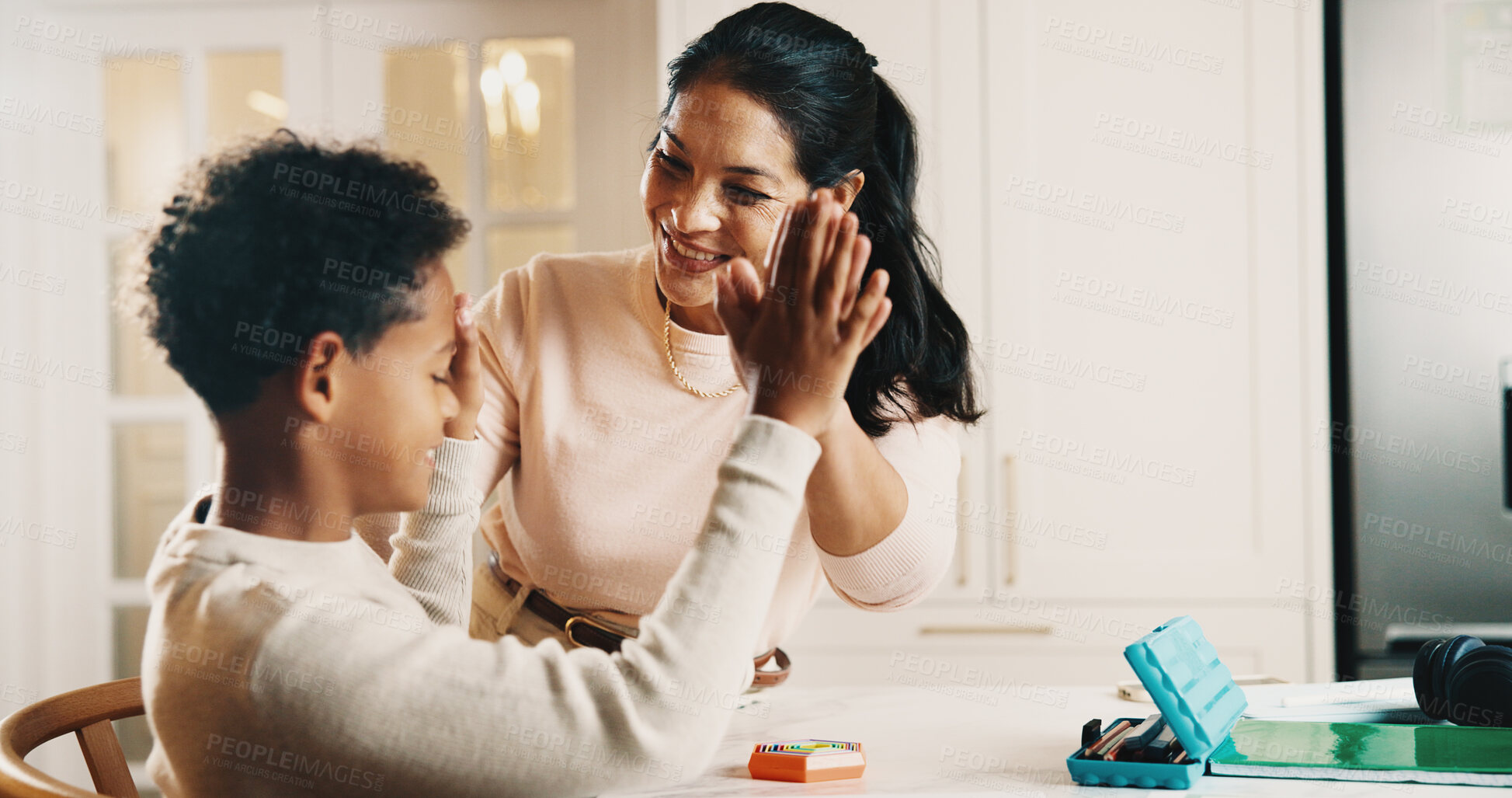Buy stock photo Mother, child and high five in house with homework, learning success and cognitive development goals. Happy, woman and son with celebration for understanding task, education and achievement in home.