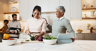 Buy stock photo Mother, grandmother and cooking at house with smile, meal prep and vegetables for healthy food. Happy, women or cutting ingredients in kitchen with tablet, culinary skills and online recipe for lunch