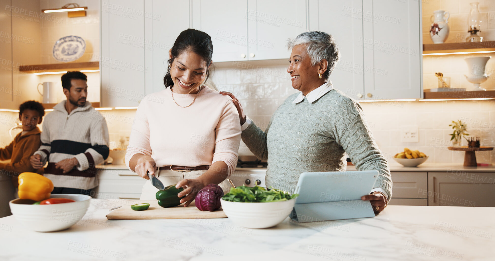 Buy stock photo Mother, grandmother and cooking at house with smile, meal prep and vegetables for healthy food. Happy, women or cutting ingredients in kitchen with tablet, culinary skills and online recipe for lunch