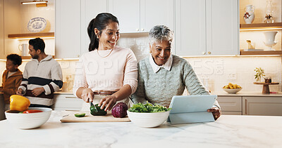 Buy stock photo Smile, family and cooking in kitchen with tablet, meal prep and online recipe for healthy food. Mother, grandmother and digital at house with vegetables, tutorial video and culinary skills for lunch