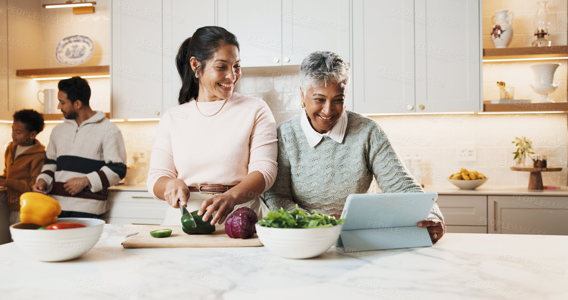 Buy stock photo Smile, family and cooking in kitchen with tablet, meal prep and online recipe for healthy food. Mother, grandmother and digital at house with vegetables, tutorial video and culinary skills for lunch