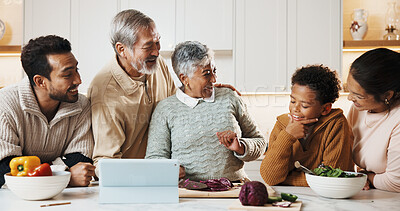 Buy stock photo People, cooking and big family in kitchen for meal prep, supper and prepare food for bonding in home. Generations, happy child and tablet for online recipe, conversation and connection for holiday