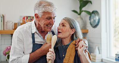 Buy stock photo Cooking, karaoke or old couple in kitchen with spoon, fun moment or bonding with culinary hobby. Happy, groove or elderly people with meal prep, singing performance or playful connection in home.