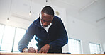 Architect, writing and black man in office with plan, design review and draft of renovation project. Development, below and engineer with notes, progress checklist and strategy brief for remodeling.