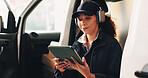 Woman, headphones and tablet by delivery van with break, reading or check courier info with music. Person, supply chain employee and relax by transport with technology, shipping details and podcast