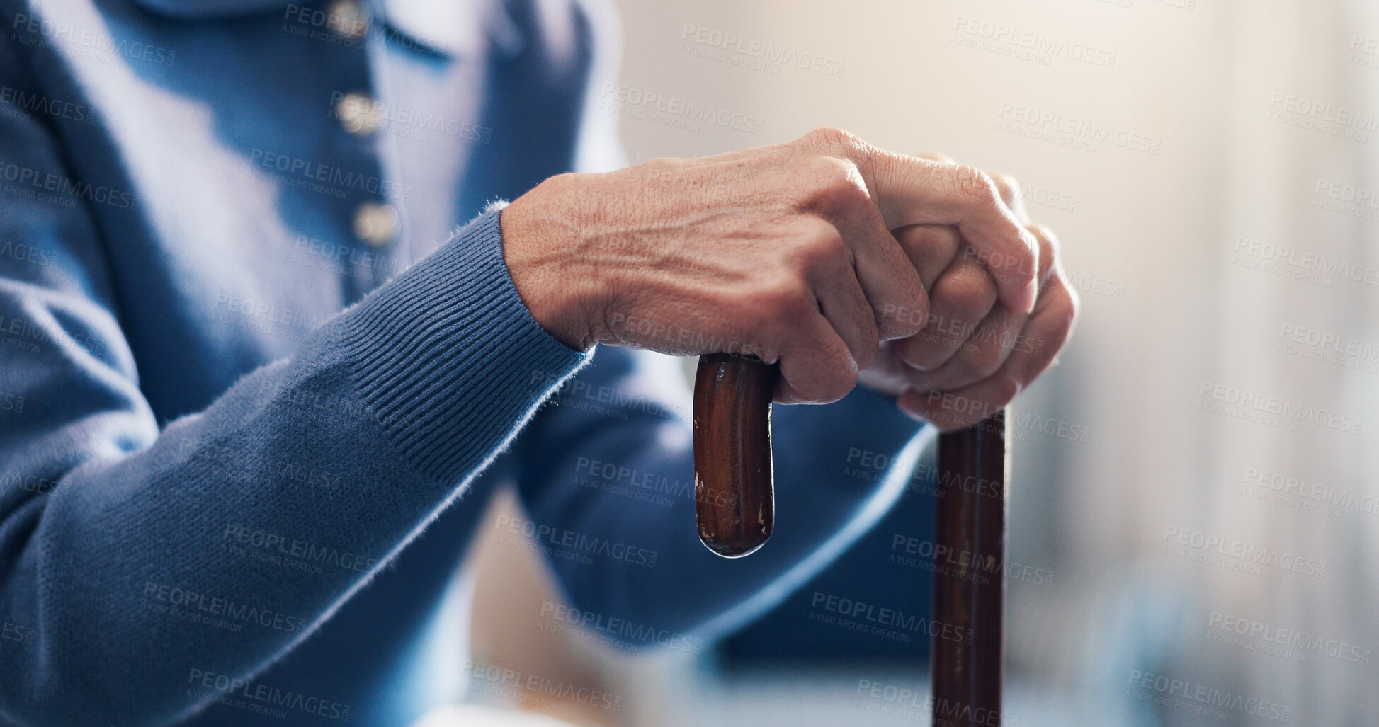 Buy stock photo Senior, person and hands with cane in retirement home for balance, support or medical aid. Elderly, patient or pensioner with walking stick for healthcare comfort, assistance or help in nursing house