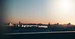 Ocean, sunset and port in city with ships, buildings or maritime transport for global trade industry. Space, boats and cargo vessel outdoor by sea with dock, international courier and freight export.