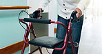 Hospital, retirement and hands with rollator in hallway, senior care or rehabilitation with balance. Clinic, patient and old person with disability, healing and walk with walker and stroke recovery
