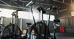 Empty, fitness and air bike in gym for cardio, wellness facility and setup for spin class with flare. Stationary bicycle, interior and equipment in training studio for cycling, development or machine