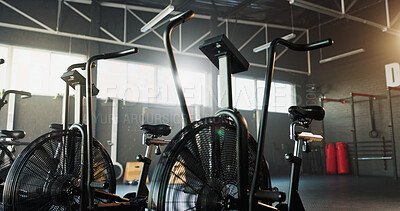Buy stock photo Empty, fitness and air bike in gym for cardio, wellness facility and setup for spin class with gear. Stationary bicycle, interior and equipment in training studio for cycling, development or machine