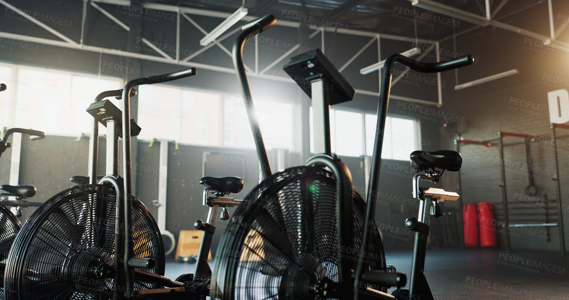 Buy stock photo Empty, fitness and air bike in gym for cardio, wellness facility and setup for spin class with gear. Stationary bicycle, interior and equipment in training studio for cycling, development or machine