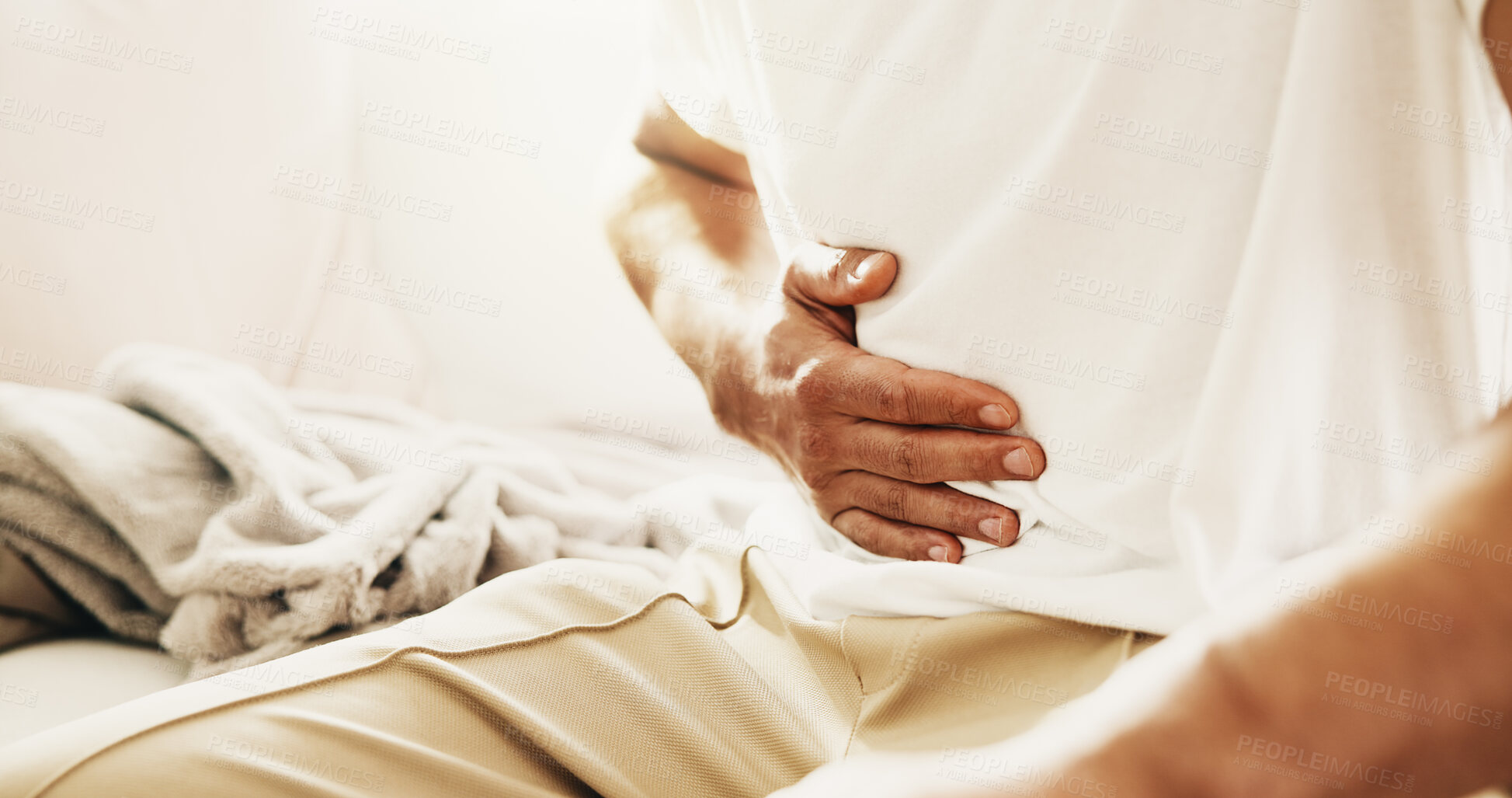 Buy stock photo Man, hands and sick on sofa with stomach ache, allergy or constipation from irritable bowel syndrome. Person, abdomen pain and cramps in house with indigestion, disease and gas from bloating problem.