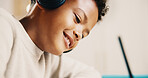 Happy, boy and writing with headphones in home for childhood education, learning or homework. Child, kid or student with smile or pen for creative development, drawing or academic activity in house