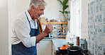 Singing, cooking and senior man with spoon in kitchen at house with music, radio or album on weekend. Happy, karaoke and elderly person listening to online playlist for preparing dinner in apartment.