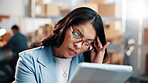 Ecommerce, headache and woman in depot with tablet, logistics stress and backlog for order delivery. Tired, person and migraine in warehouse with tech, glasses and crisis for shipping distribution.