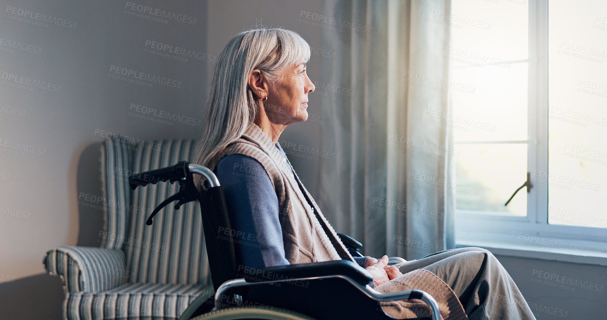 Buy stock photo Thinking, wheelchair and window with old woman in retirement home for memories or nostalgia. Flare, remember and senior person with disability in living room for contemplation, ideas or morning view